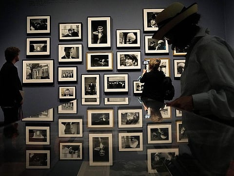 Visitors look at pictures during a preview of Paul McCartney Photographs 1963-64: Eyes of the Storm exhibition at the National Portrait Gallery in London.