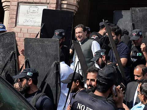 Pakistan's former Prime Minister Imran Khan, centre, leaves after appearing in a court in Lahore, Pakistan, Monday, June 26, 2023.