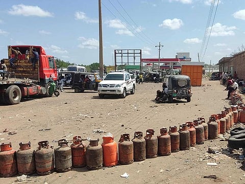 People wait for a new shipment of liquefied petroleum gas (LPG) cylinders in the city of Gadaref, the capital of Sudan's eastern state of Gadaref, on June 26, 2023.
