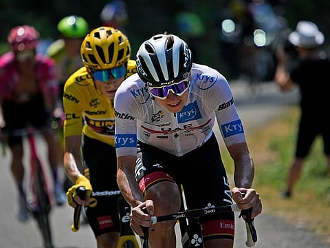 Slovenia's Tadej Pogacar, wearing the best young rider's white jersey, tries to break away from Denmark's Jonas Vingegaard, wearing the overall leader's yellow jersey