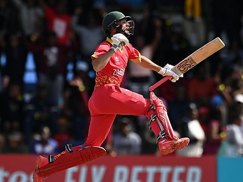 Sean Williams of Zimbabwe celebrates his century during the ICC Men's Cricket World Cup Qualifier Super 6 match against Oman at Queen’s Sports Club in Bulawayo on Thursday.