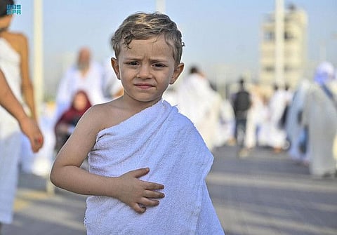 A child attends Hajj alongside his parents.