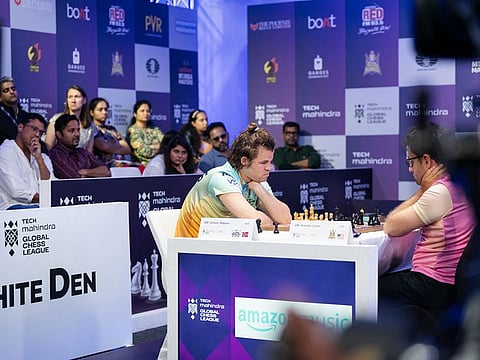 Magnus Carlsen in action watched by Mahesh Bhupathi, a long-time friend of Anand, during the match between Warriors and Kings.