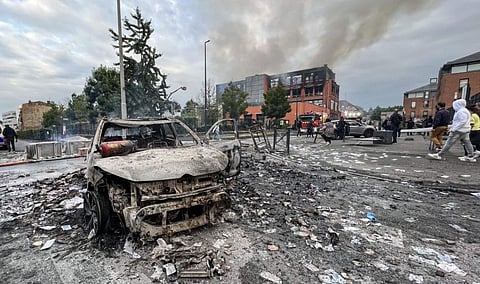A burnt out vehicle stands on a street in front of the fire damaged Tessi group building in the Alma district of Roubaix on June 30, 2023, which was completely destroyed by fire during protests after a 17-year-old boy was shot in the chest by police at point-blank range in Nanterre, a western suburb of Paris. . The building, which housed a data processing company for banks and insurance companies, completely burned down, following another night of tension after the death of the teenage driver in the Paris suburb of Nanterre on June 27.