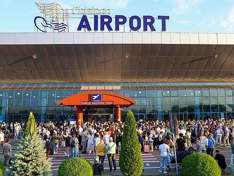 Travellers crowd the entrance to the Chisinau airport in Moldova.