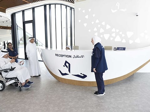 An Emirati senior citizen and member of Thukhor Club interacting with staff during his visit