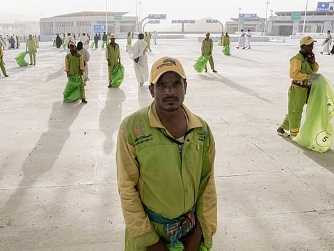 Cleaners line up in front of pilgrims after they cast stones at a pillar in the symbolic stoning of the devil, the last rite of the annual Hajj pilgrimage, in Mina near Mecca.