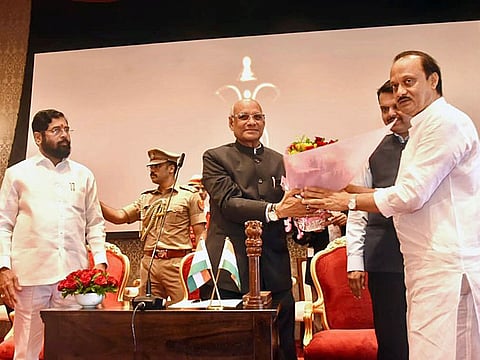 Maharashtra Governor Ramesh Bais congratulates the newly sworn-in State Deputy Chief Minister Ajit Pawar during a ceremony, as State CM Eknath Shinde and State Deputy CM Devendra Fadnavis look on, at Raj Bhavan, in Mumbai on Sunday.