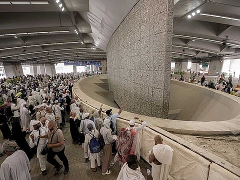 Pilgrims cast stones at a pillar in the symbolic stoning of the devil, the last rite of the annual Hajj pilgrimage, in Mina near Mecca, Saudi Arabia.