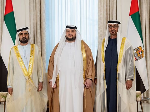 His Highness Sheikh Mohamed bin Zayed Al Nahyan, President of the United Arab Emirates (R), and His Highness Sheikh Mohammed bin Rashid Al Maktoum, Vice-President, Prime Minister of the UAE, Ruler of Dubai and Minister of Defence (L), stand for a photograph with newly appointed minister, Mohamed Hassan Al Suwaidi, UAE Minister of Investment (C), during the oath ceremony at Shati Palace on Thursday.