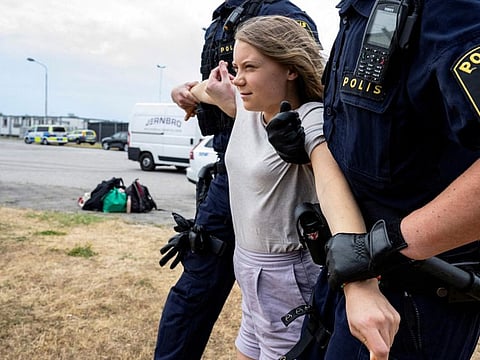 Police remove Greta Thunberg as they move climate activists from the organization Ta Tillbaka Framtiden, who are blocking the entrance to Oljehamnen in Malmo, Sweden, June 19, 2023.