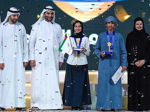 Sarah Al Amiri, UAE Minister of State for Public Education and Advanced Technology with Arab reading challenge winners Amna Mohammed Al Mansouri and Ghareeb Mohammed Al Yamahi in Dubai.