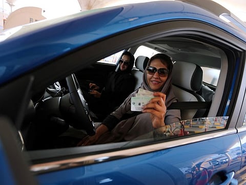 A Saudi woman shows her national ID at the Bahrain immigration checkpoint, as she drives to Bahrain on the King Fahd Causeway, a bridge connecting the two countries, on Bahrain-Saudi border, August 22, 2019.