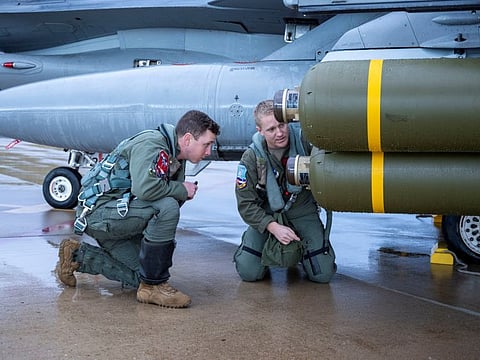 US Air Force's Nathan Paige and Andrew "Chaos" Davis from the Colorado Air National Guard do a final inspect of a cluster bomb at Hill Air Force Base, Utah, on January 10, 2023.