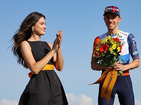 Canadian rider Michael Woods celebrates his victory on the podium after winning the 9th stage of the 110th edition of the Tour de France race in the Massif Central volcanic mountains in central France on Sunday.
