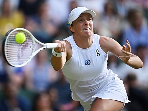 Poland's Iga Swiatek in action during her fourth round match against Switzerland's Belinda Bencic in Wimbledon on Sunday.