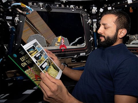 Sultan Al Neyadi reading Tintin aboard the ISS.