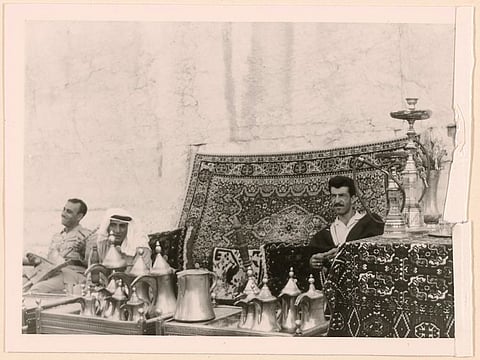 Lebanon. Merchants and a musician playing a guembri. 1966.