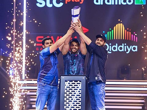 Pakistani gamer Arslan Ash, Imran Khan, and Atif Butt raise the coveted trophy after winning Gamers8 Tekken 7 Nations Cup in Riyadh, Saudi Arabia, on July 9, 2023.
