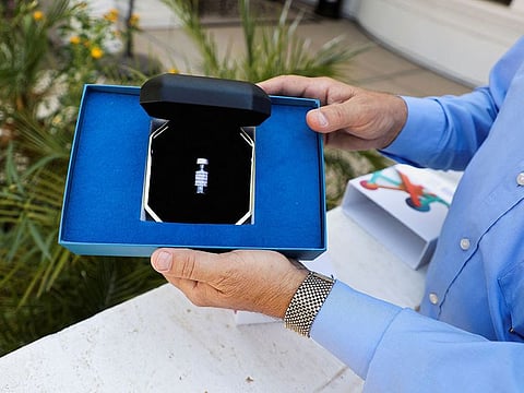 Gerry Paulus holds a DNA Memorial Kit given to families by Celestis, inc. as a keepsake for those who use their space burials service, in Mesa, Arizona.