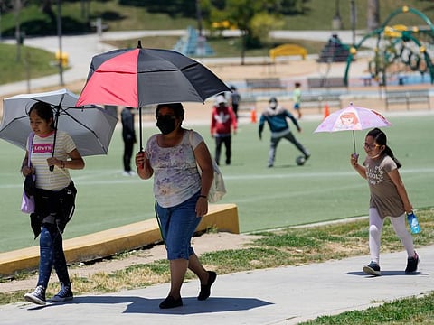 Visitors at MacArthur Park in Los Angeles on July 11, 2023.