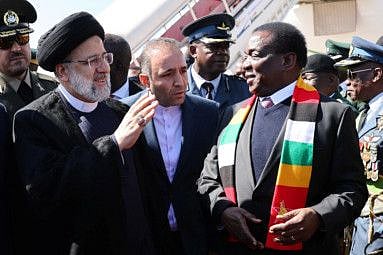 Iranian President Ebrahim Raisi is welcomed by Zimbabwean President Emmerson Mnangagwa at Harare airport in Harare on July 13, 2023.
