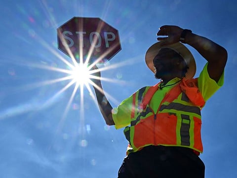 Traffic warden Rai Rogers mans his street corner during an 8-hour shift under the hot sun in Las Vegas, Nevada, on July 12, 2023.
