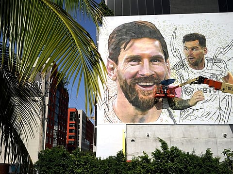 Artist Maximiliano Bagnasco paints a mural of Lionel Messi in the Wynwood neighborhood of Miami.