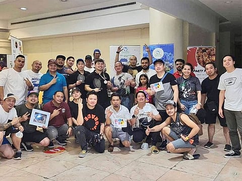 Members of the UAE Pinoy Betta Club (UPBC), including Genuino (seated fifth from left) at the Saturday fighter fish beauty contest in Dubai.
