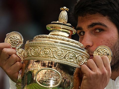 Spain’s Carlos Alcaraz kisses the winner’s trophy after beating Serbia’s Novak Djokovic during the men’s singles final of the 2023 Wimbledon Championships at The All England Tennis Club in Wimbledon, southwest London, on July 16, 2023. The Spaniard won the five-setter for his second grand slam title, following the win at last year’s US Open.