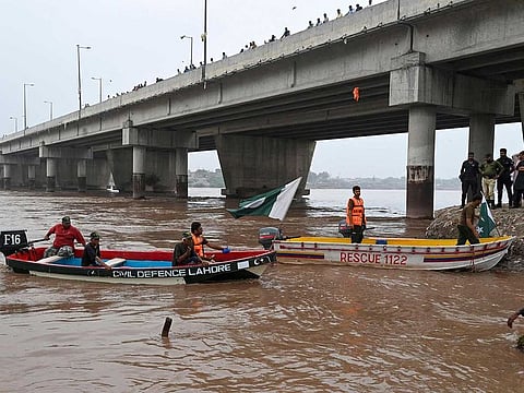 Pakistan's civil defence rescue workers monitor the flood-affected river Ravi in Lahore on July 16, 2023.
