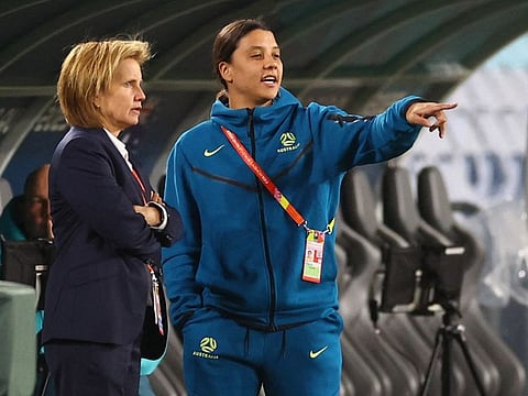 Australia's Sam Kerr interacts with an official during a visit to the stadium in Sydney on Wednesday.