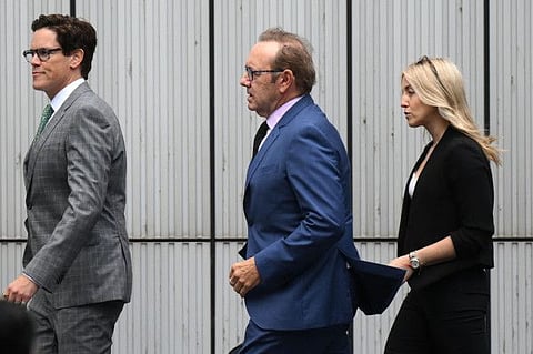 US actor Kevin Spacey (centre) arrives at the Southwark Crown Court in London.