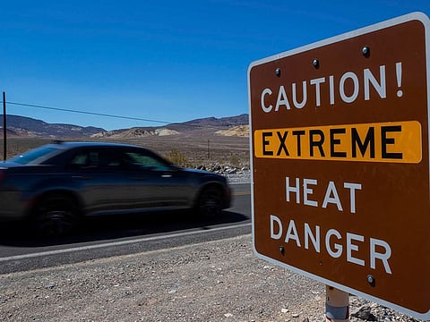 A sign stands warning of extreme heat in Death Valley National Park, Calif. July is the hottest month at the park with an average high of 116 degrees (46.5 Celsius).