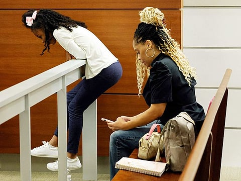Olivia Caraballo, 8, and her mother, Philana Holmes, are shown in the courtroom gallery after the jury began deliberations at the Broward County Courthouse in Fort Lauderdale on Wednesday, July 19, 2023.