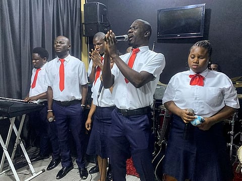 Visually impaired pastor Chimaobi Nduka sings with the faithful during blind people's Sunday church service at Bethesda Home for the Blind in Lagos, Nigeria.