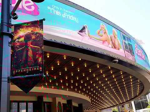 Advertisements for the films "Oppenheimer" and "Barbie" appear at AMC Theaters at The Grove on Thursday