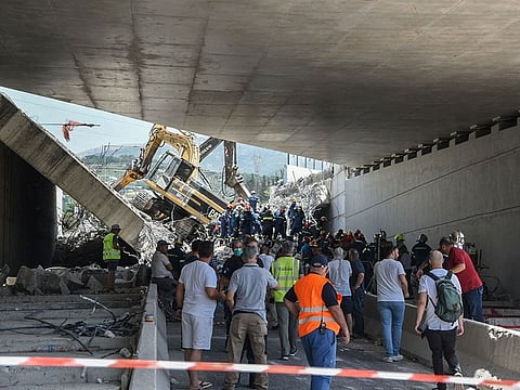 People are seen at the site of a bridge that collapsed in Patras, Greece.