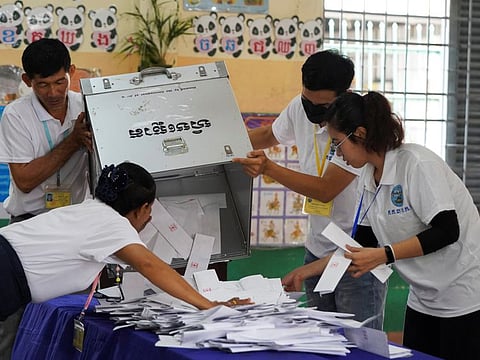 Election officials count ballots at a polling station on the day of Cambodia's general election, in Phnom Penh, Cambodia, July 23, 2023.
