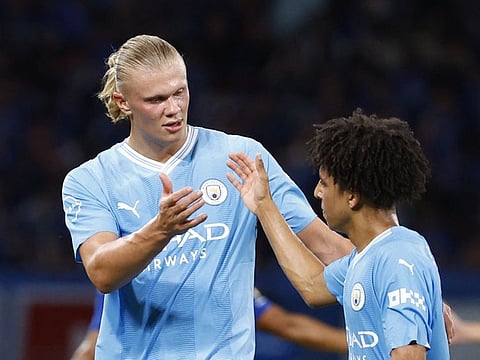 Manchester City's Erling Braut Haaland shakes hands with Rico Lewis after the friendly against Yokohama F Marinos at the Japan National Stadium, Tokyo on Sunday.