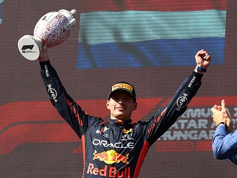 Red Bull's Max Verstappen celebrates on the podium with the trophy after winning the Hungarian Grand Prix at Hungaroring, Budapest on Sunday.