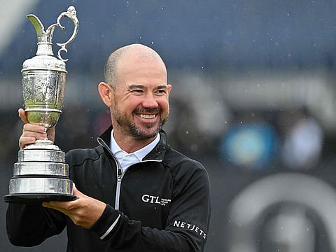 US golfer Brian Harman poses with the Claret Jug after winning the 151st British Open Golf Championship at Royal Liverpool Golf Course in Hoylake on Sunday.