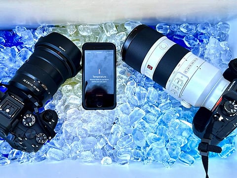 The cameras and cell phone of Associated Press photographer Ross Franklin sit on ice after the devices stopped working after overheating, Thursday, July 20, 2023, in Tempe, Arizona. Phoenix photographers keep coolers for cameras, towels and water in their vehicles when covering extreme heat.