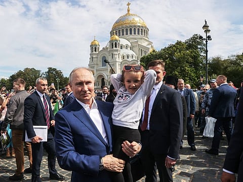 Russian President Vladimir Putin meets people outside the Naval Cathedral of St. Nicholas in Kronstadt near Saint Petersburg, Russia July 23, 2023.