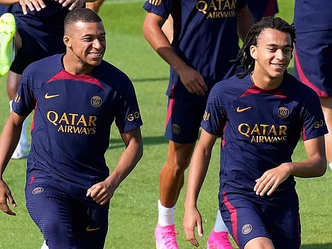Kylian Mbappe, left, and his brother Ethan Mbappe attend a training session at the new Paris Saint-Germain training center Thursday, July 20, 2023 in Poissy, west of Paris.