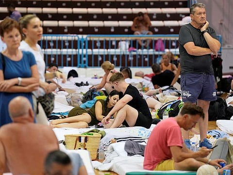 Tourists are sheltered in a sports hall after being evacuated following a wildfire on the island of Rhodes, Greece, July 23, 2023.