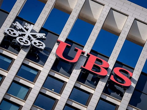 FILE - The logo of Swiss bank UBS is fixed on a building where the bank has offices in Frankfurt, Germany, Nov. 8, 2022. Swiss banking giant UBS will pay nearly $400 million in fines to U.S., Swiss and U.K. banking authorities for the management failures of Credit Suisse, which UBS bought in June 2023, related to how Credit Suisse handled its relationship with collapsed hedge fund Archegos Capital Management. (AP Photo/Michael Probst, File)