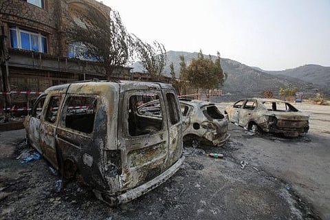 Burnt vehicles are pictured in the aftermath of a wildfire in Bejaia, Algeria July 25, 2023. REUTERS/Ramzi Boudina