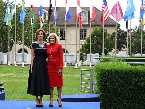 US First Lady Jill Biden and Unesco Director General Audrey Azoulay poses in front of flags during a flag raising ceremony for the return of the United States to Unesco after an over half decade absence at the headquarters in Paris, on July 25, 2023.