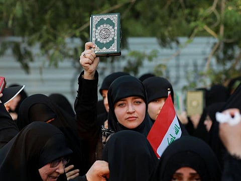 Supporters of Iraq's Hashed Al Shaabi (Popular Mobilisation) group take part in a protest denouncing the burning of the Quran.